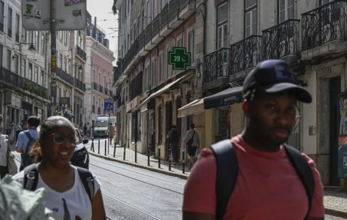 Pedestrians walk past a pharmacy sign showing 39 degrees Celsius (102 Fahrenheit) as high temperatures hit Lisbon, Portugal on June 28, in 2025. Horacio Villalobos/Corbis News/Getty Images