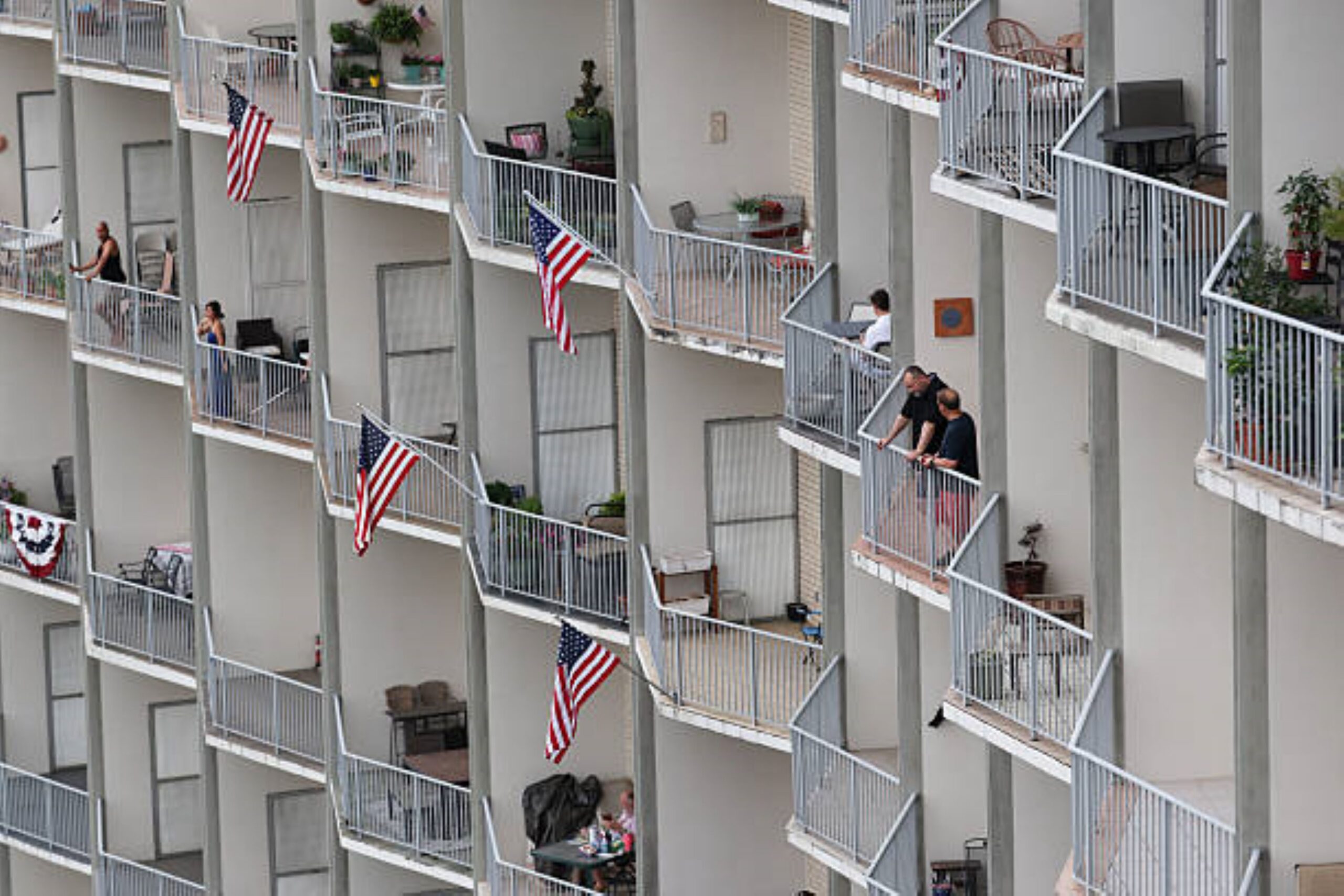People gather on balconies in Washington, D.C on July 4, 2026 at 6:33 PM. Photo: Win McNamee/Getty Images. © Getty Images.