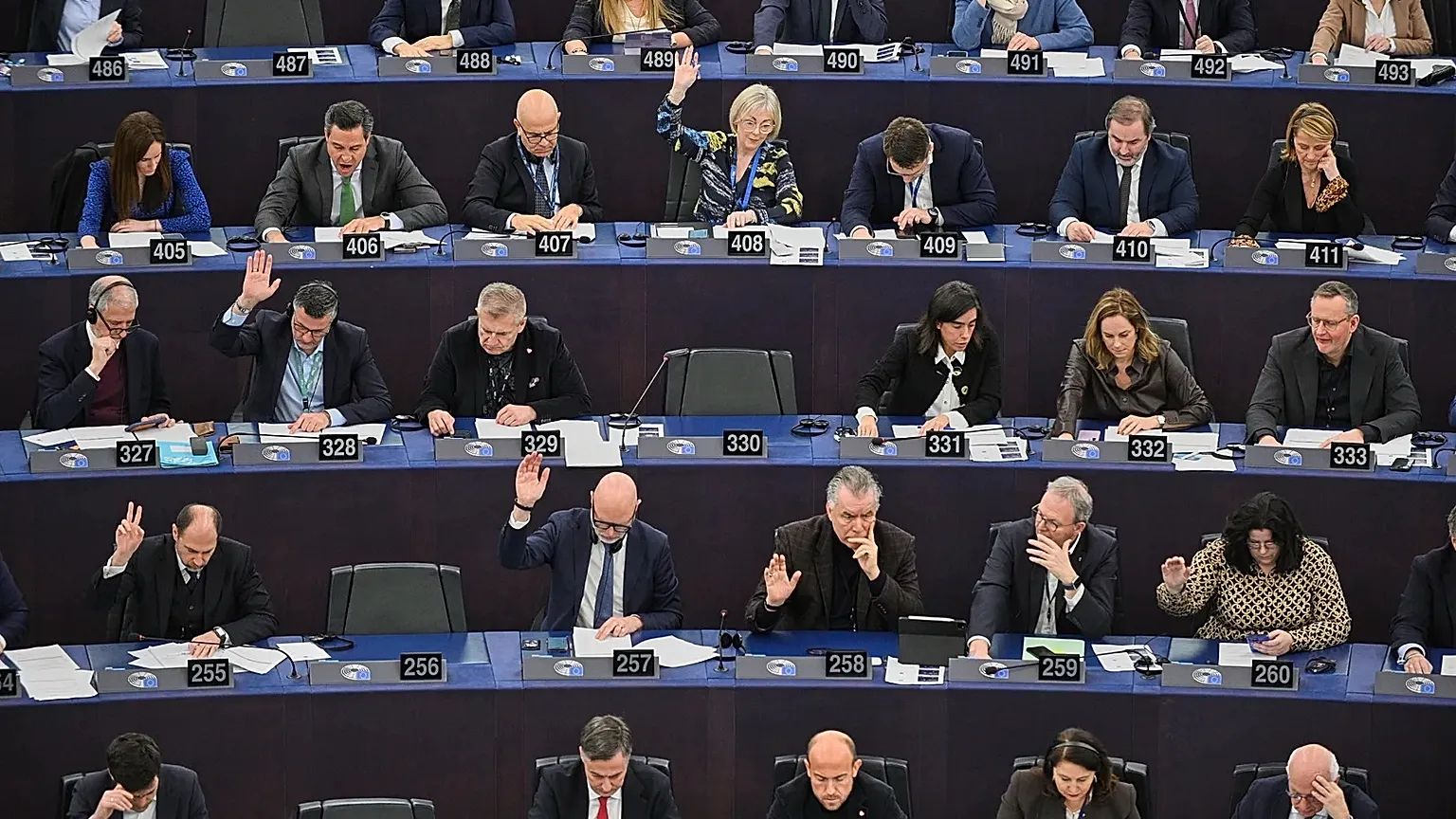 Members of the European Parliament vote by show of hands during in a plenary session at the European Parliament on July 9, 2026 at 6:55 PM. Parliament confirmed the digital euro's negotiating mandate that day, 416 votes to 169.. Photo: Pascal Bastien/AP. © @2026 AP